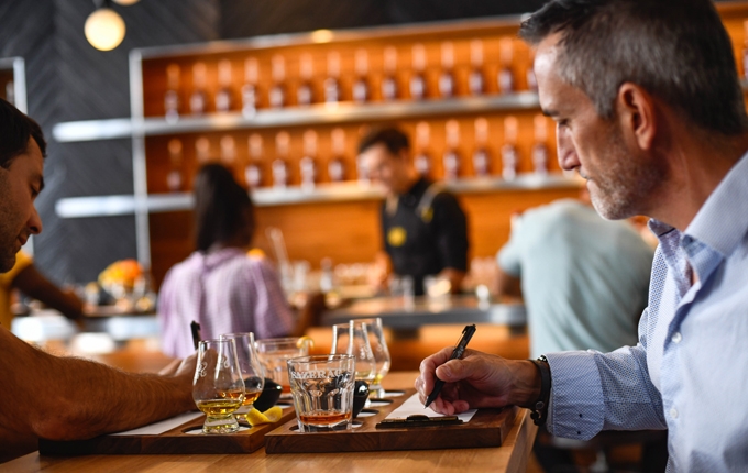 Patrons taking notes during a tasting