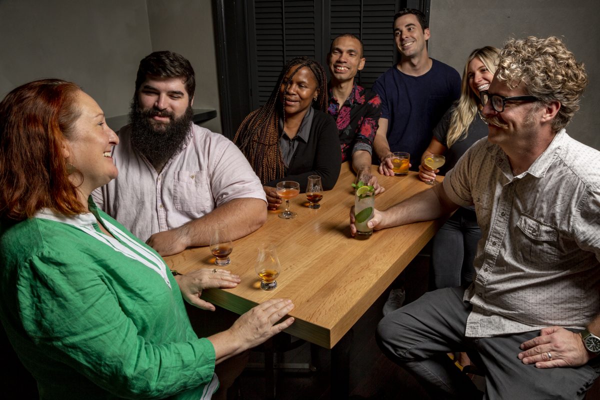 People sitting at table drinking cocktails