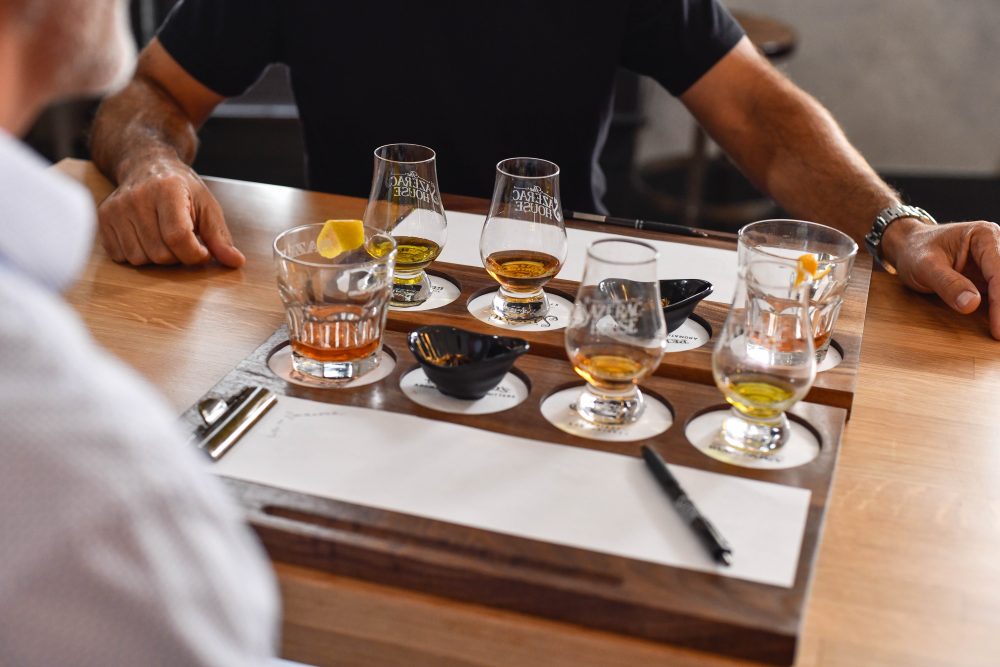 patrons enjoying a tasting with a variety of drinks