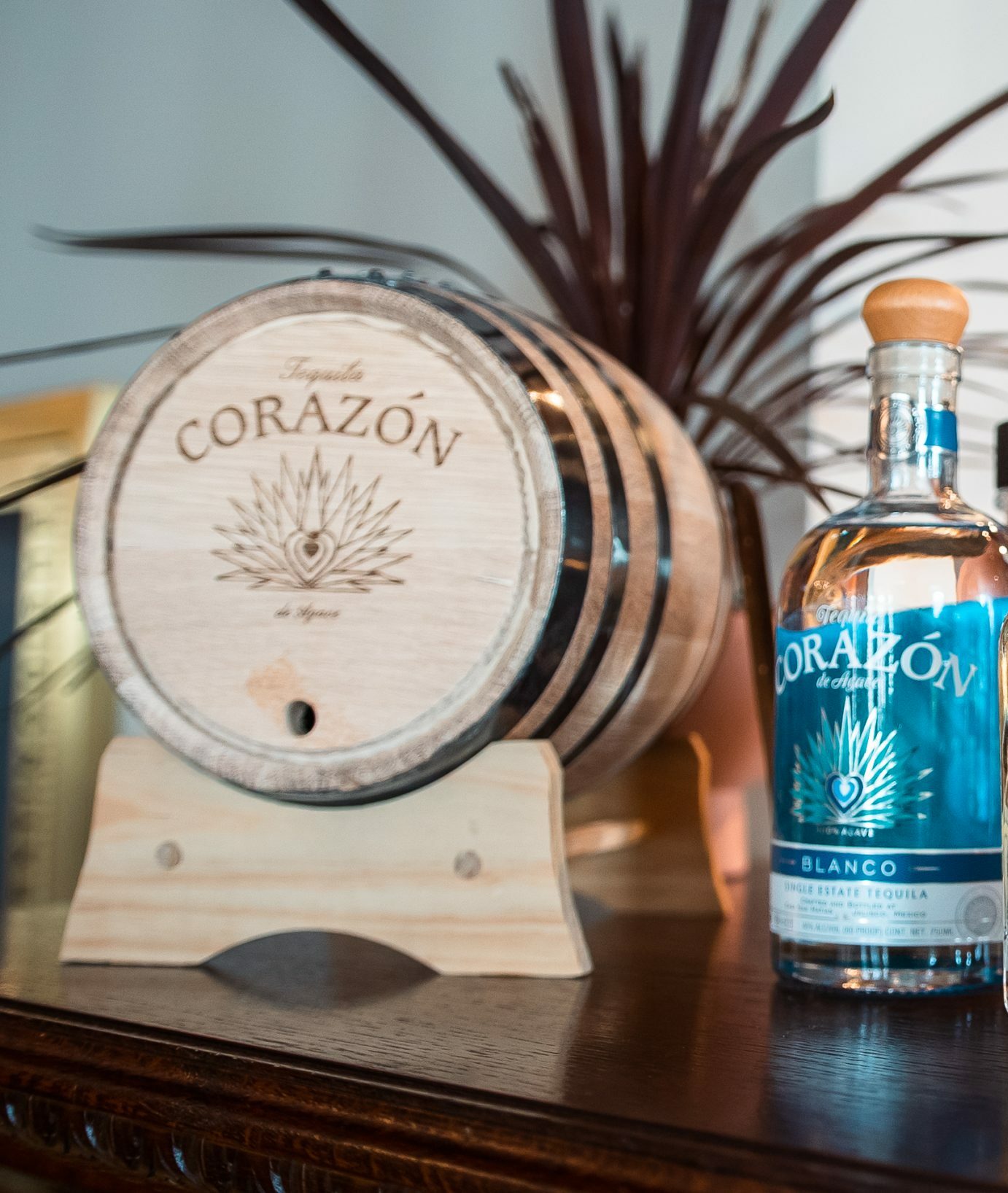 Three bottles of Premium Agave Spirits displayed on an oak bar, shown during Tales of the Cocktail at the Sazerac House.